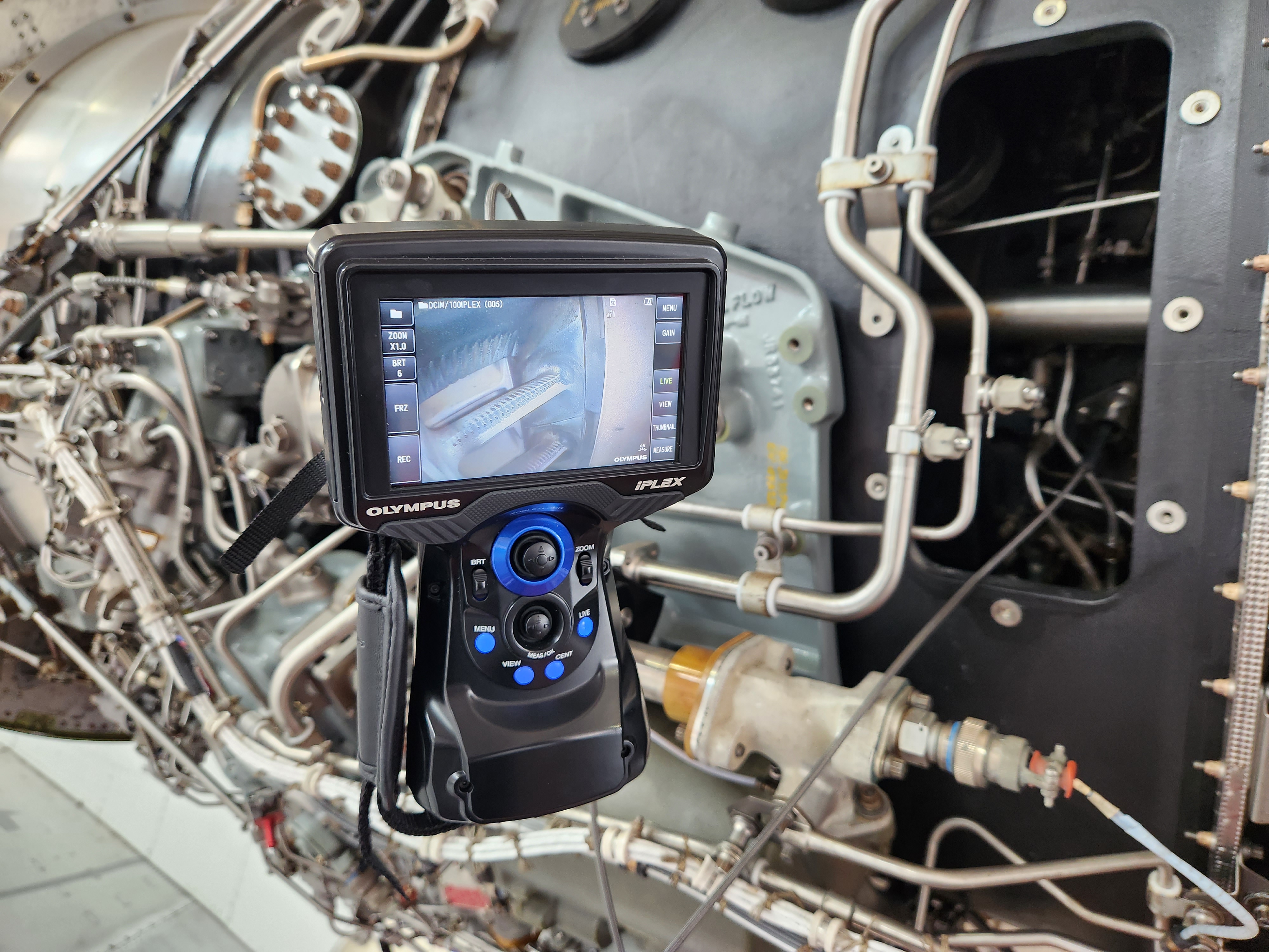 Borescope in use on a turbine engine showing blade inspection on screen